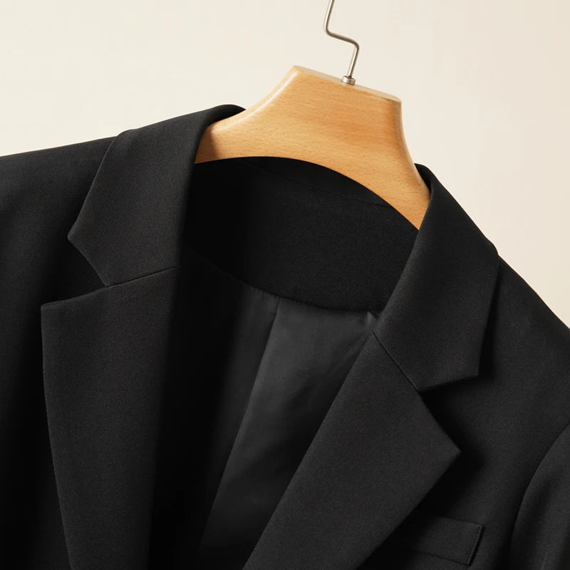 Elegant mid-length black womens blazer for autumn and winter simple one-button design with a slimming drape effect suitable for commuting