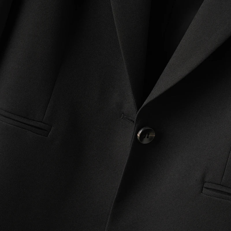Elegant mid-length black womens blazer for autumn and winter simple one-button design with a slimming drape effect suitable for commuting